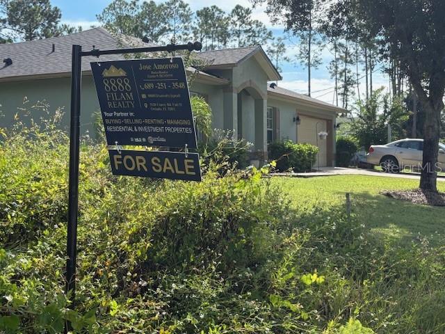 98 Sloganeer Trail Palm Coast, FL 32164 - Photo 5 of 5 a view of a house with backyard and sitting area