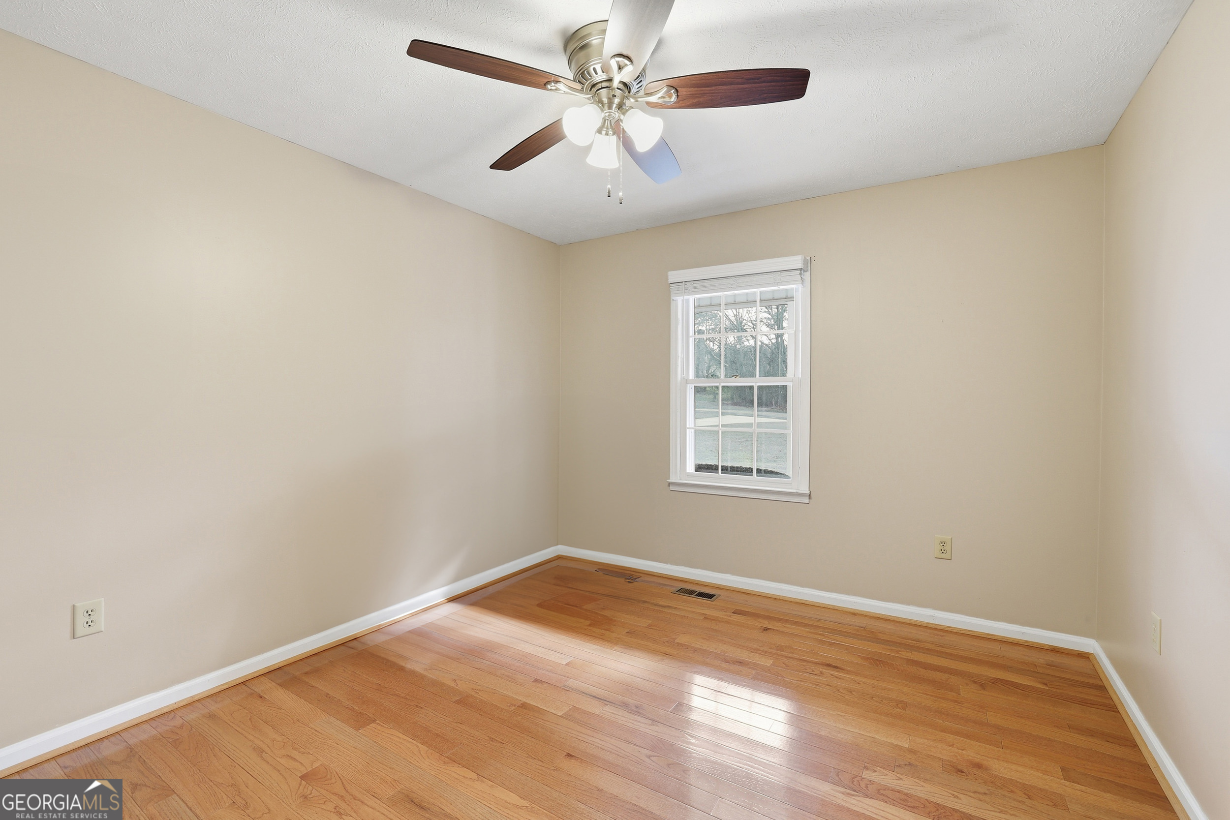 81 McMurray Road Toccoa, GA 30577 - Photo 24 of 50 an empty room with a window and a ceiling fan
