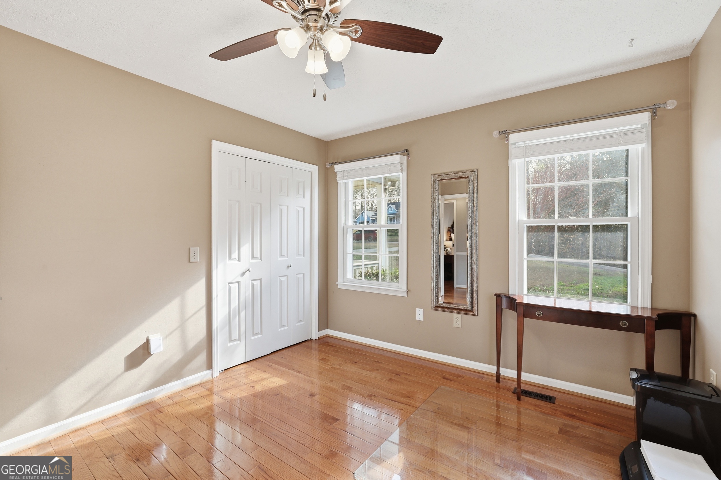 81 McMurray Road Toccoa, GA 30577 - Photo 31 of 50 an empty room with chandelier fan and windows