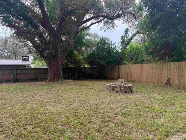 a backyard of a house with table and chairs