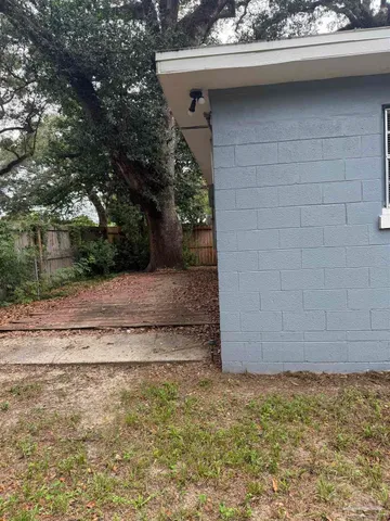 a view of a wooden door and a yard