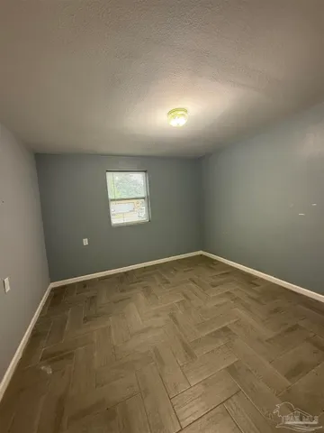 an empty room with a empty space and windows