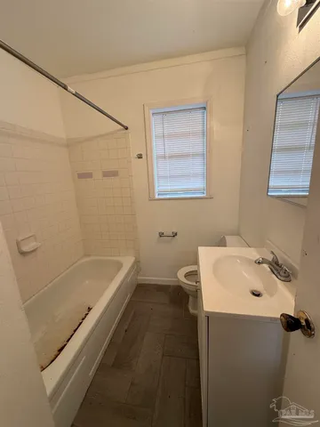 a bathroom with a bathtub sink and toilet