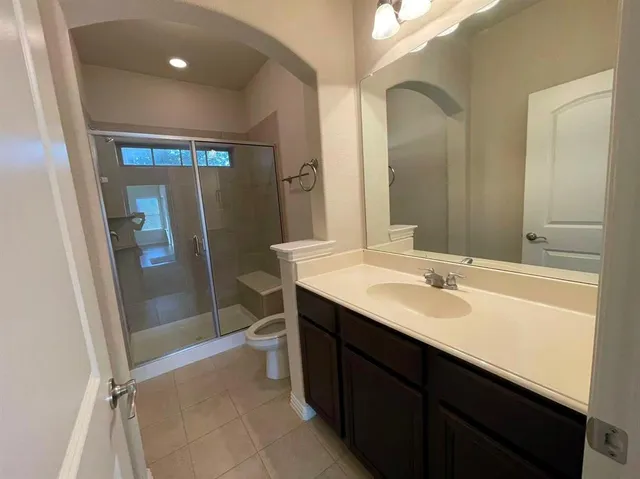 a bathroom with a sink a mirror and a shower