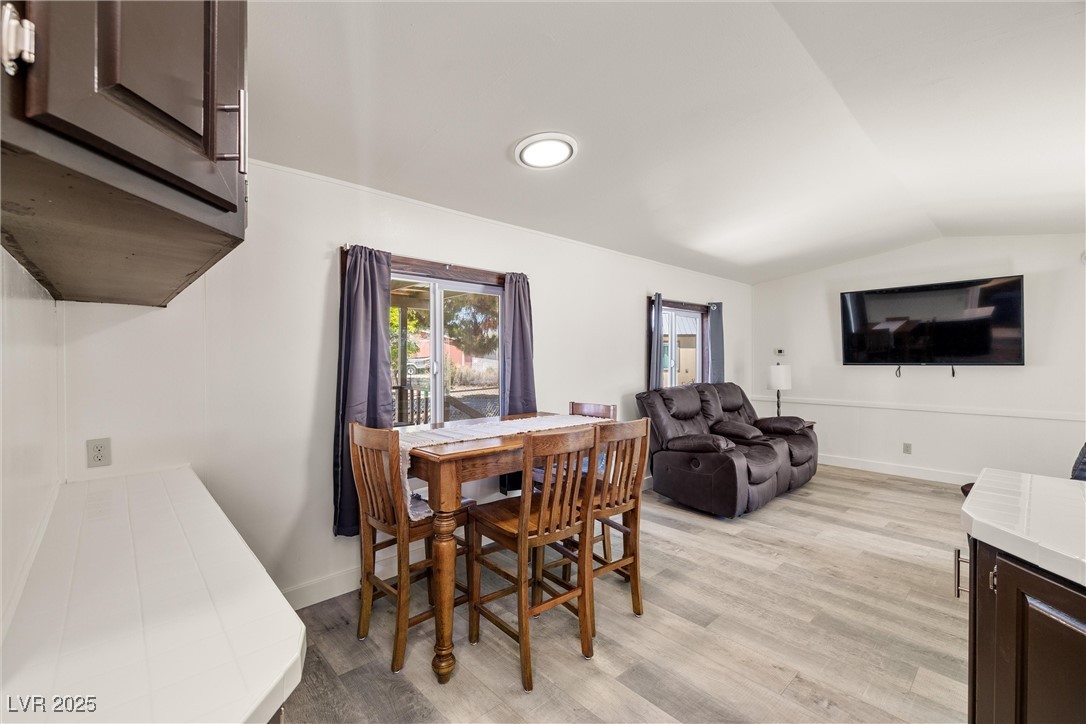 1771 East Brian Road Pahrump, NV 89048 - Photo 11 of 29 Dining space featuring vaulted ceiling, light wood-style flooring, and recessed lighting