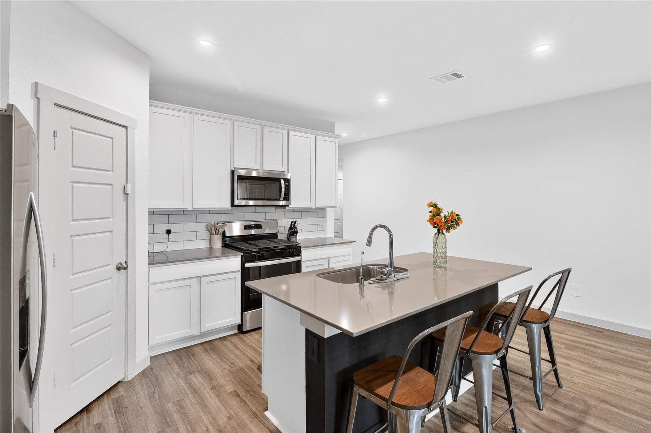 7907 Sleek Flock Lane Rosharon, TX 77583 - Photo 13 of 28 The dining area feels defined without being closed off, with easy access to the kitchen that makes everything from weeknight dinners to entertaining more functional.