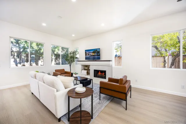 a living room with fireplace furniture and a flat screen tv