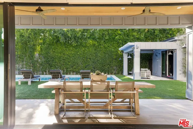 a view of a patio with table and chairs and potted plants