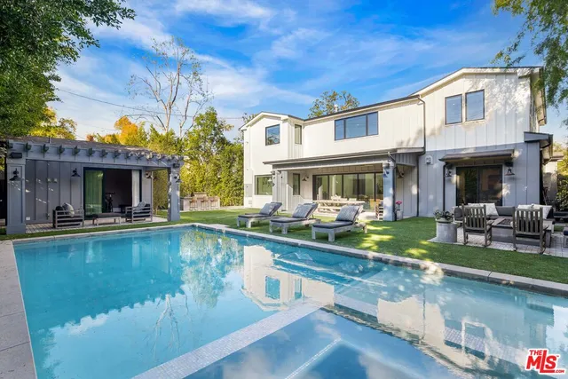 a view of a house with swimming pool table and chairs