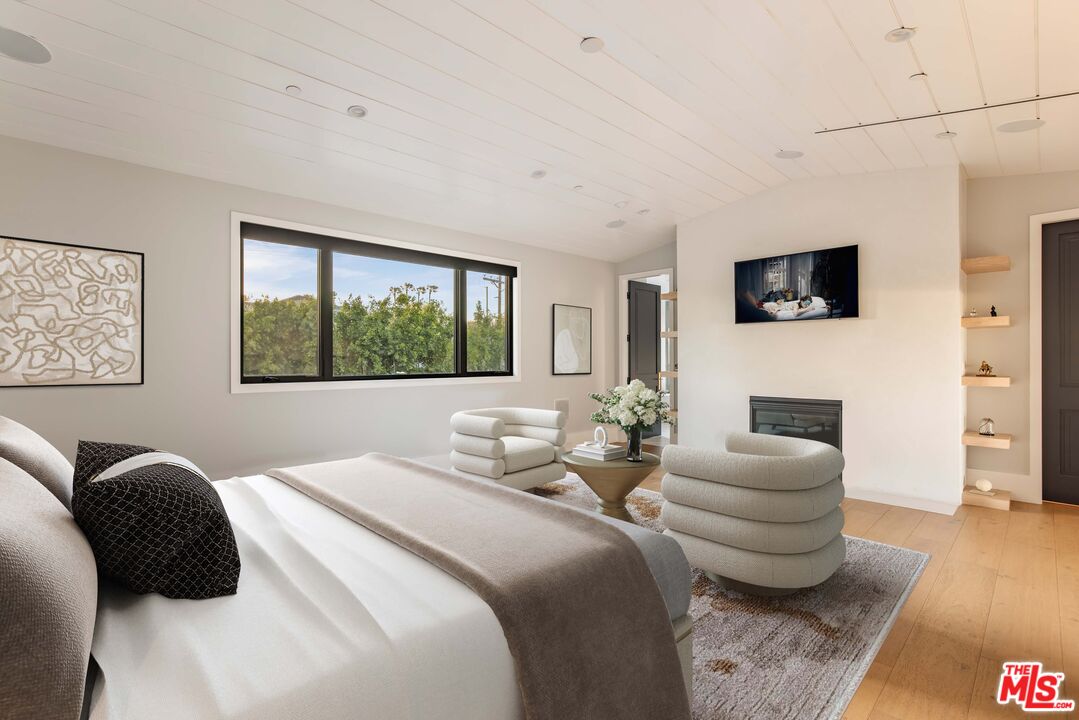 4533 Gentry Avenue Studio City, CA 91607 - Photo 18 of 39 a bedroom with a bed a couch and a flat screen tv