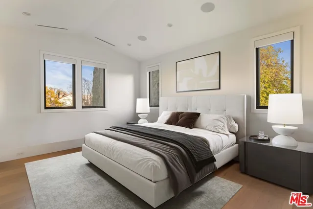 a bedroom with a bed and a painting on the wall