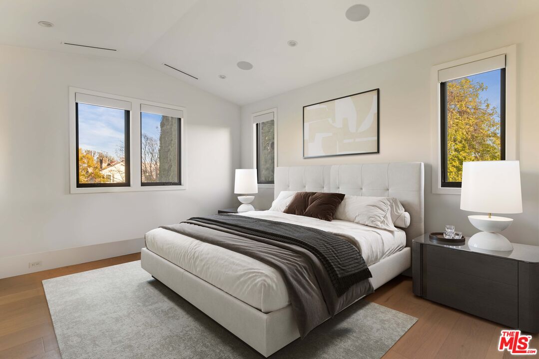 4533 Gentry Avenue Studio City, CA 91607 - Photo 23 of 39 a bedroom with a bed and a painting on the wall