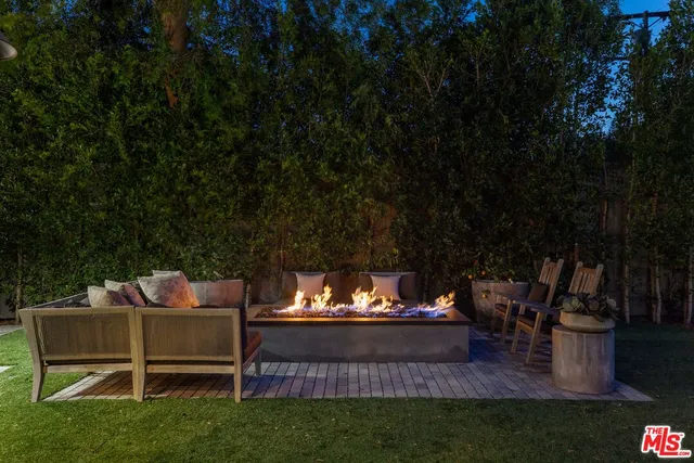 a view of a chairs and table in the garden