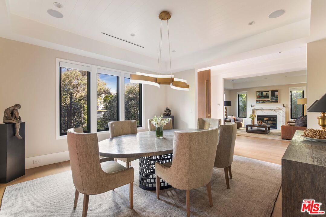 4533 Gentry Avenue Studio City, CA 91607 - Photo 7 of 39 a dining room with furniture a chandelier and wooden floor