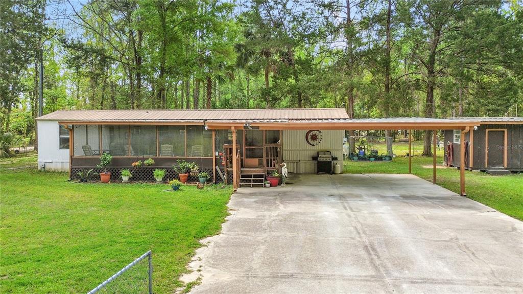 3650 176 Place Inglis, FL 34449 - Photo 2 of 49 a view of a house with garden and porch