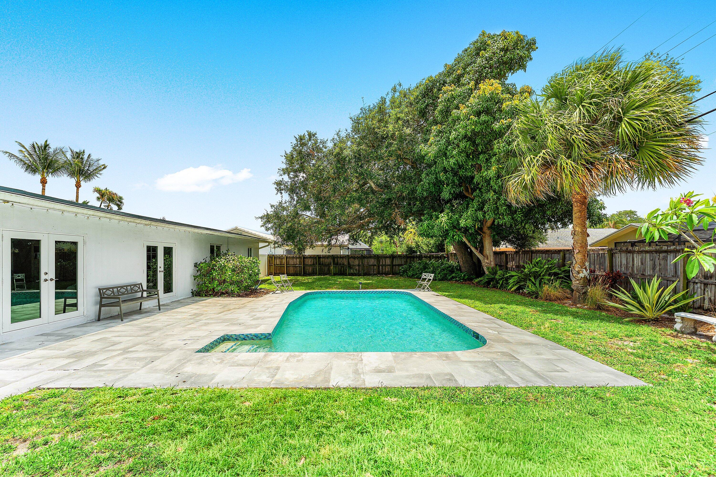581 Northwest 13th Drive Boca Raton, FL 33486 - Photo 36 of 39 a view of backyard with swimming pool and seating space