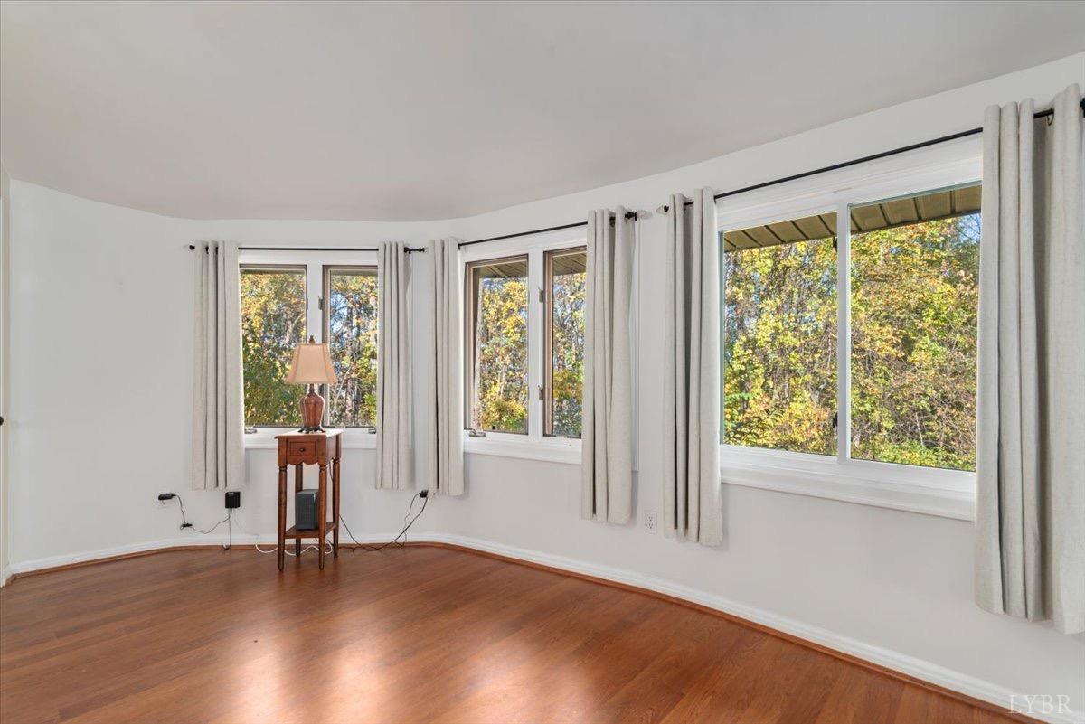 1052 Sardis Road Amherst, VA 24521 - Photo 9 of 46 a view of an empty room with wooden floor and a window