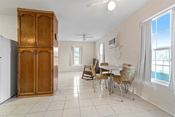 a dining room with furniture and windows