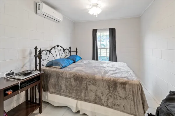 a bedroom with a bed and a window