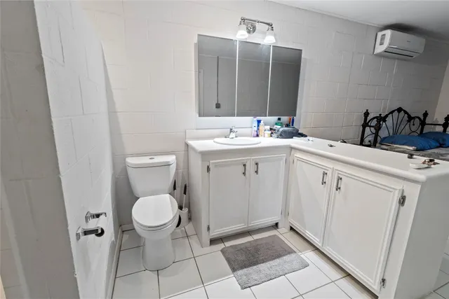 a spacious bathroom with a toilet sink and mirror