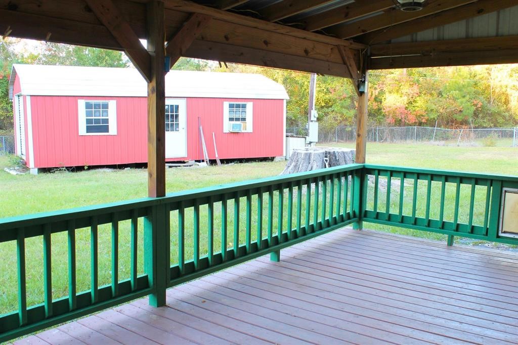 1493 Mollywood Road Zavalla, TX 75980 - Photo 6 of 22 a view of a wooden deck next to a yard