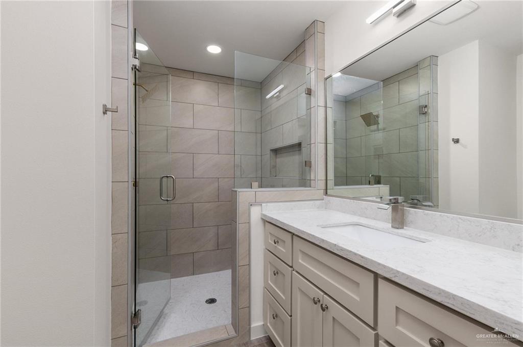 349 Barcelona Street Donna, TX 78537 - Photo 14 of 19 a bathroom with a shower sink and mirror
