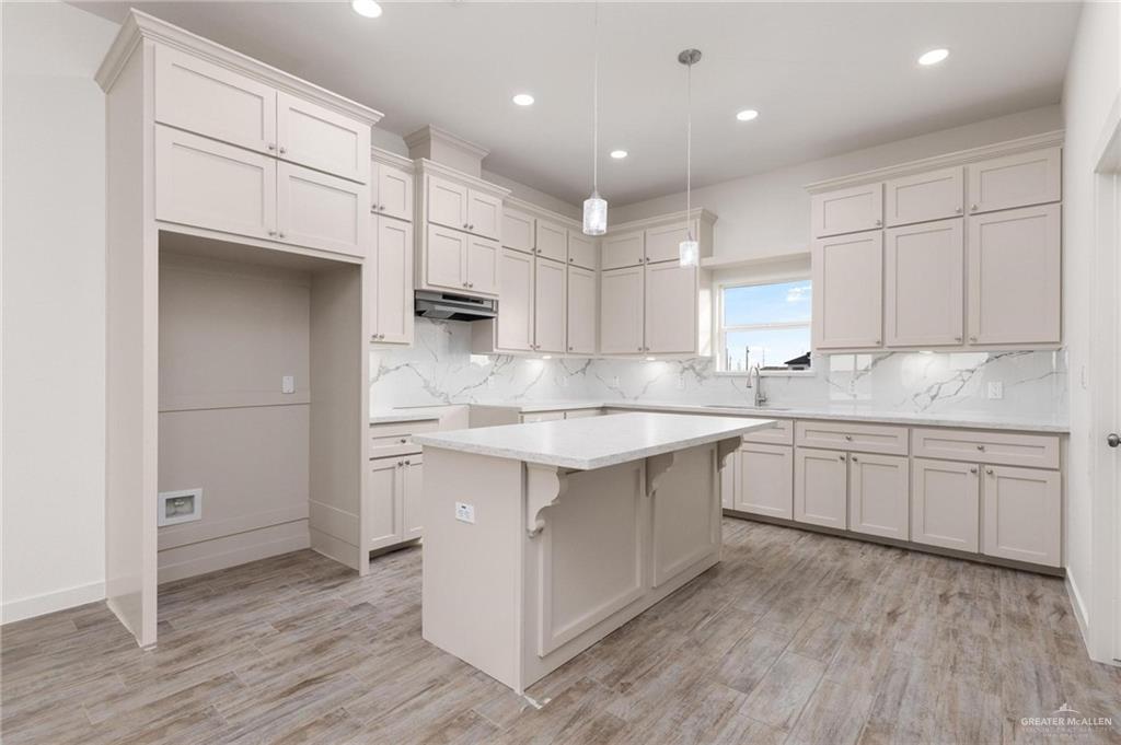 349 Barcelona Street Donna, TX 78537 - Photo 2 of 19 a kitchen with kitchen island cabinets and wooden floor