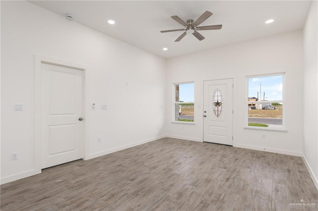 349 Barcelona Street Donna, TX 78537 - Photo 3 of 19 wooden floor in an empty room with a window