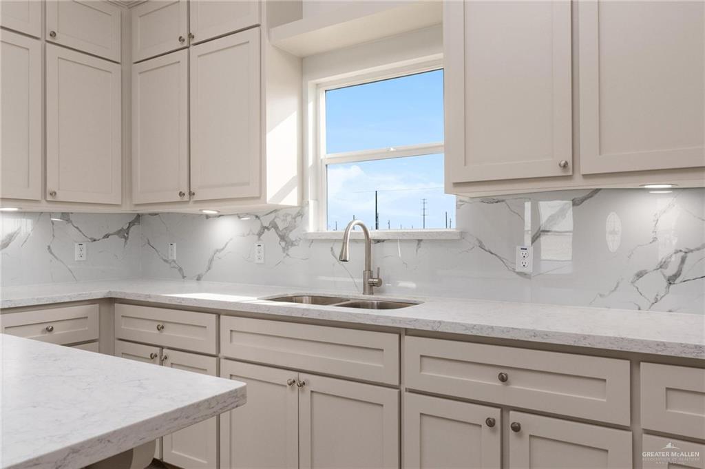 349 Barcelona Street Donna, TX 78537 - Photo 4 of 19 a kitchen with white cabinets and a sink