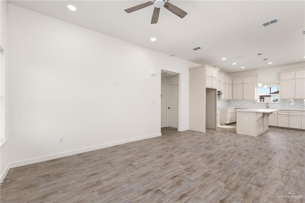 349 Barcelona Street Donna, TX 78537 - Photo 5 of 19 a view of a kitchen with stainless steel appliances a refrigerator counter top and white cabinets