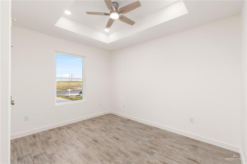 349 Barcelona Street Donna, TX 78537 - Photo 7 of 19 an empty room with a window and a ceiling fan