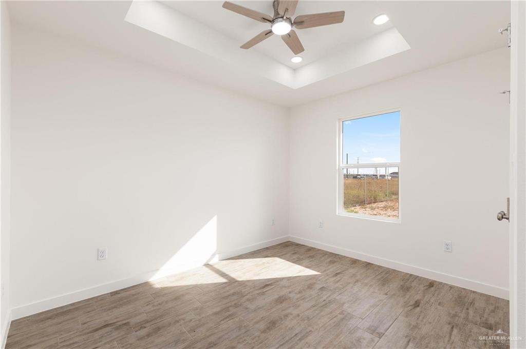 349 Barcelona Street Donna, TX 78537 - Photo 10 of 19 an empty room with wooden floor and window