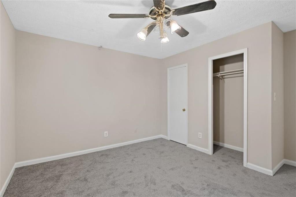 7519 Conkle Road Jonesboro, GA 30236 - Photo 16 of 35 an empty room with windows and fan