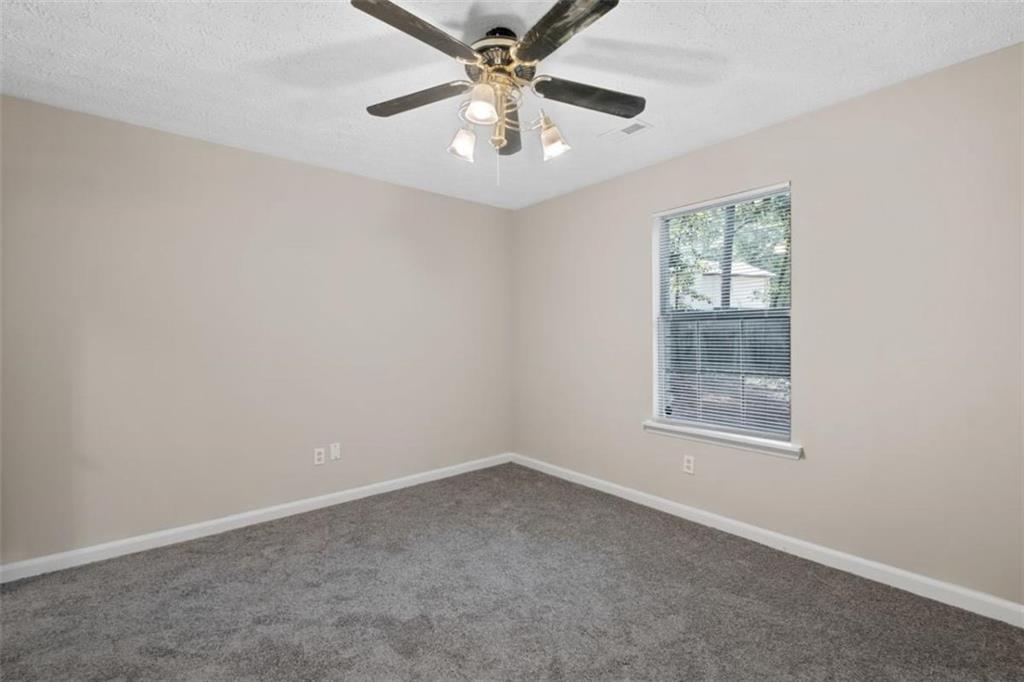 7519 Conkle Road Jonesboro, GA 30236 - Photo 17 of 35 an empty room with a window and a fan