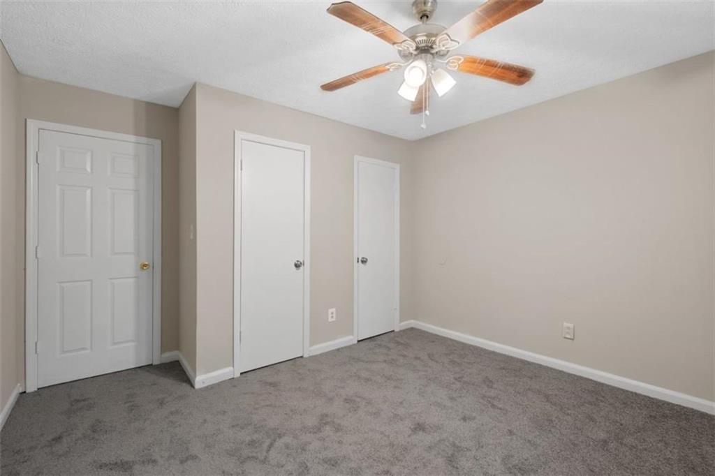 7519 Conkle Road Jonesboro, GA 30236 - Photo 19 of 35 an empty room with closet and a ceiling fan