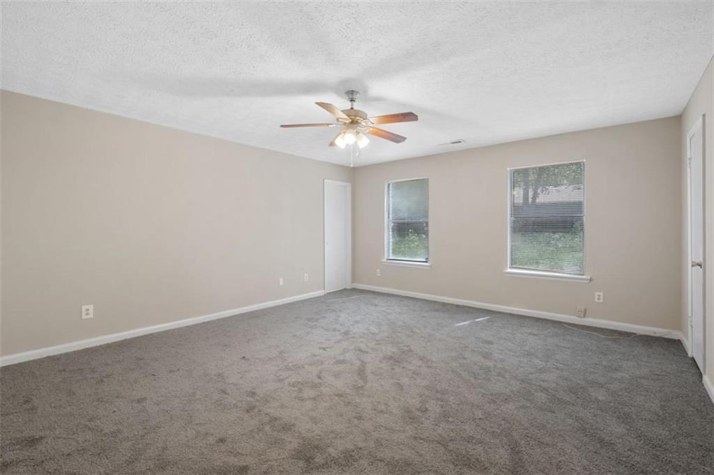 7519 Conkle Road Jonesboro, GA 30236 - Photo 20 of 35 a view of a room with a ceiling fan and a window
