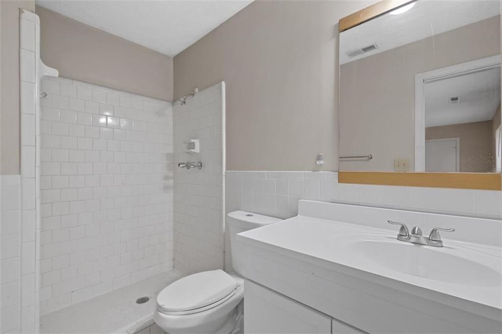 7519 Conkle Road Jonesboro, GA 30236 - Photo 24 of 35 a bathroom with a sink a toilet and shower