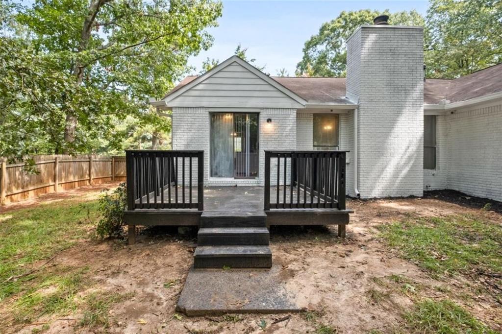 7519 Conkle Road Jonesboro, GA 30236 - Photo 26 of 35 a view of a house with backyard and deck