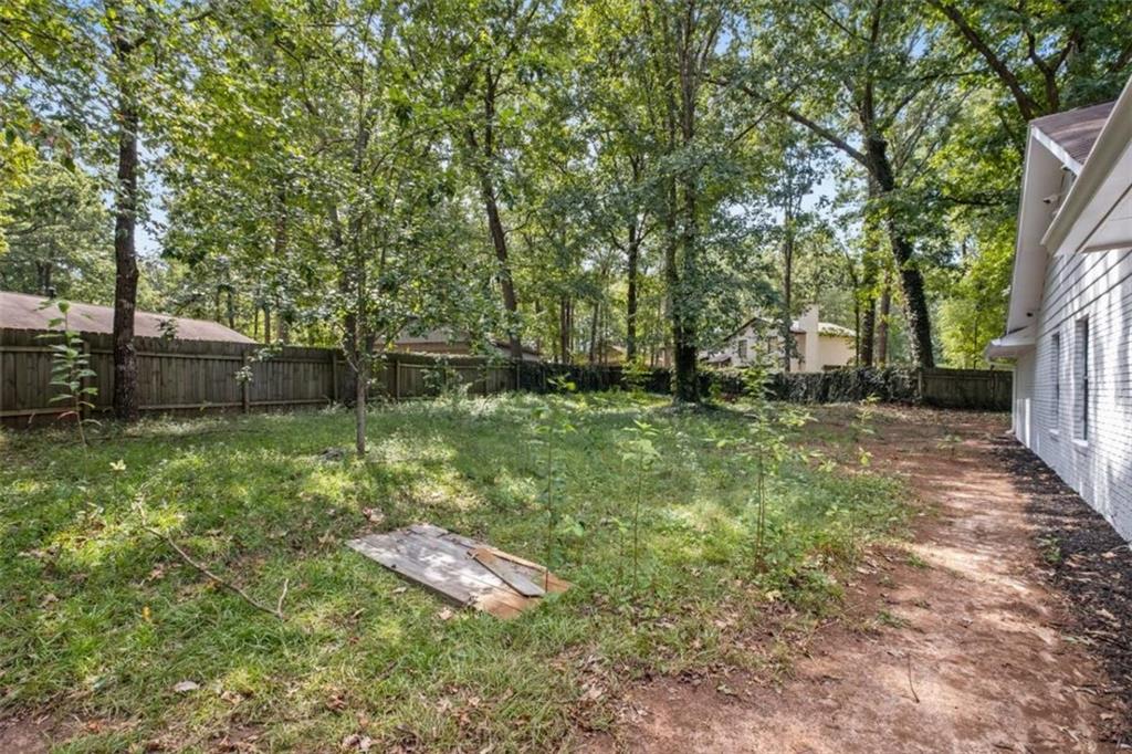 7519 Conkle Road Jonesboro, GA 30236 - Photo 30 of 35 a backyard of a house with lots of green space