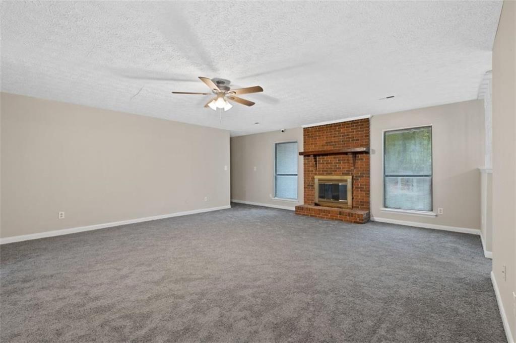 7519 Conkle Road Jonesboro, GA 30236 - Photo 3 of 35 an empty room with a empty space and chandelier fan