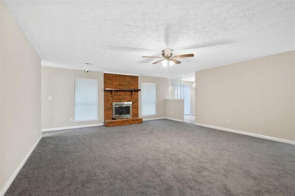 7519 Conkle Road Jonesboro, GA 30236 - Photo 4 of 35 an empty room with chandelier fan and windows