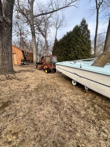 a view of a yard with a house and a tree