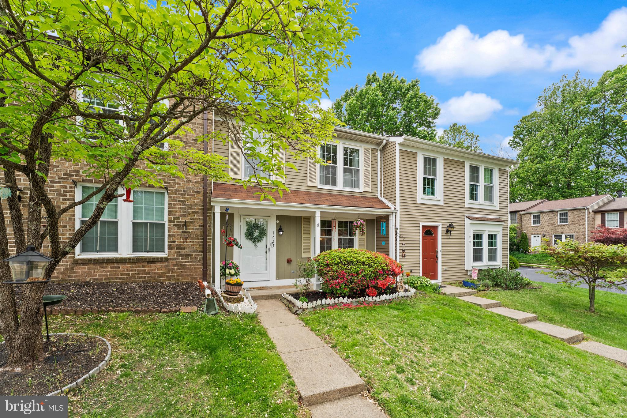1617 Sierra Woods Drive Reston, VA 20194 - Photo 1 of 39 a front view of a house with a garden