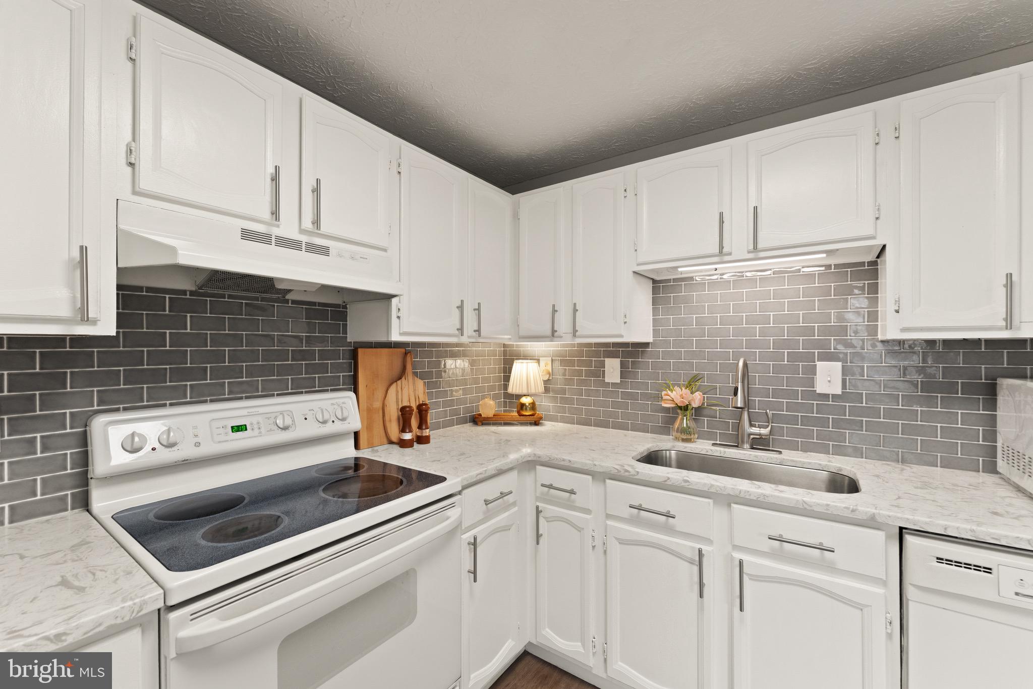 1617 Sierra Woods Drive Reston, VA 20194 - Photo 15 of 39 a kitchen with white cabinets sink and white appliances
