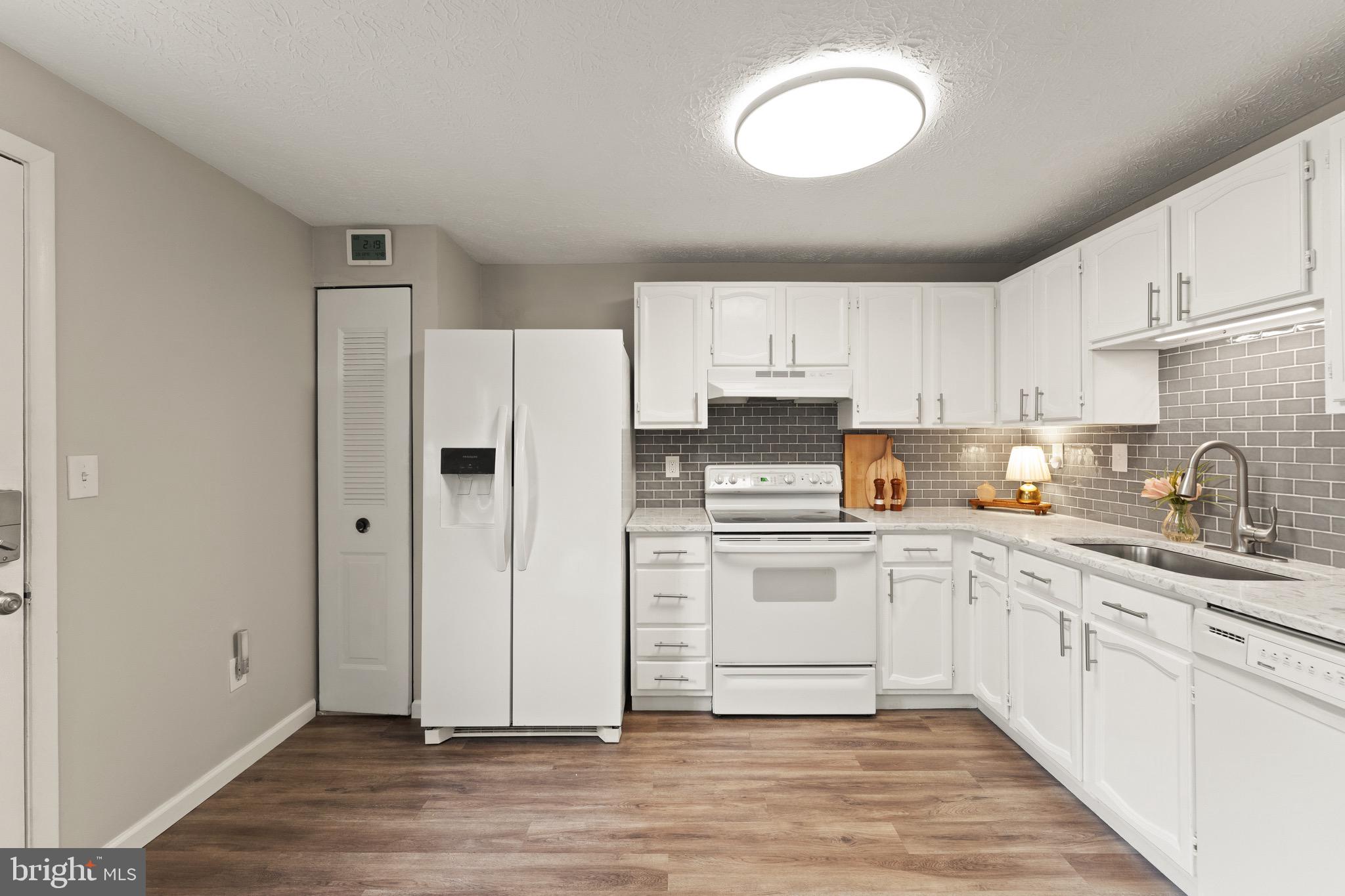 1617 Sierra Woods Drive Reston, VA 20194 - Photo 17 of 39 a kitchen with cabinets stainless steel appliances a sink and a window