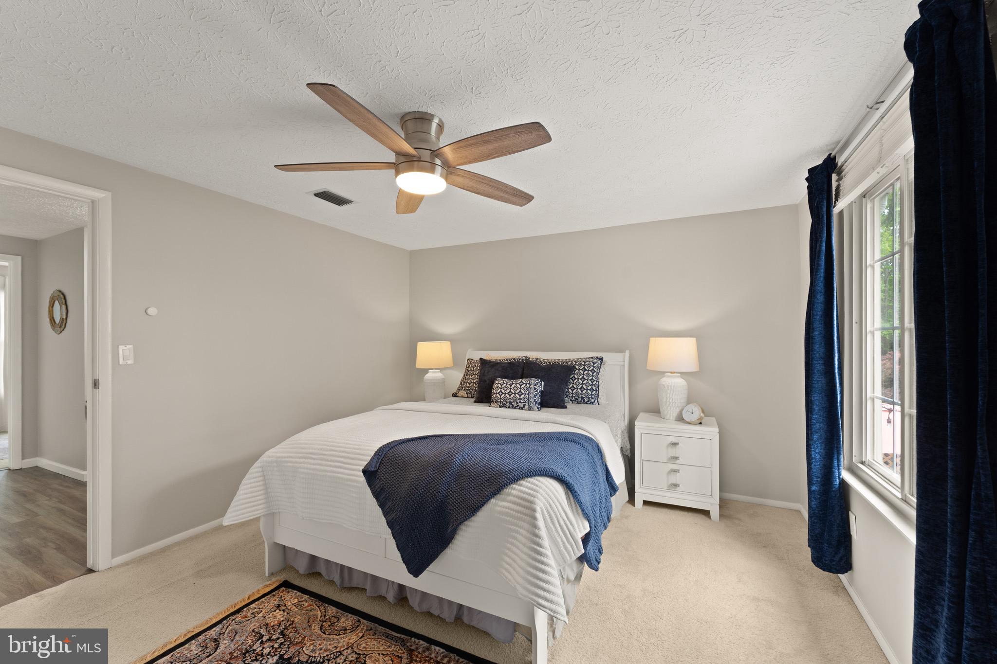 1617 Sierra Woods Drive Reston, VA 20194 - Photo 22 of 39 a bedroom with a bed and a chandelier