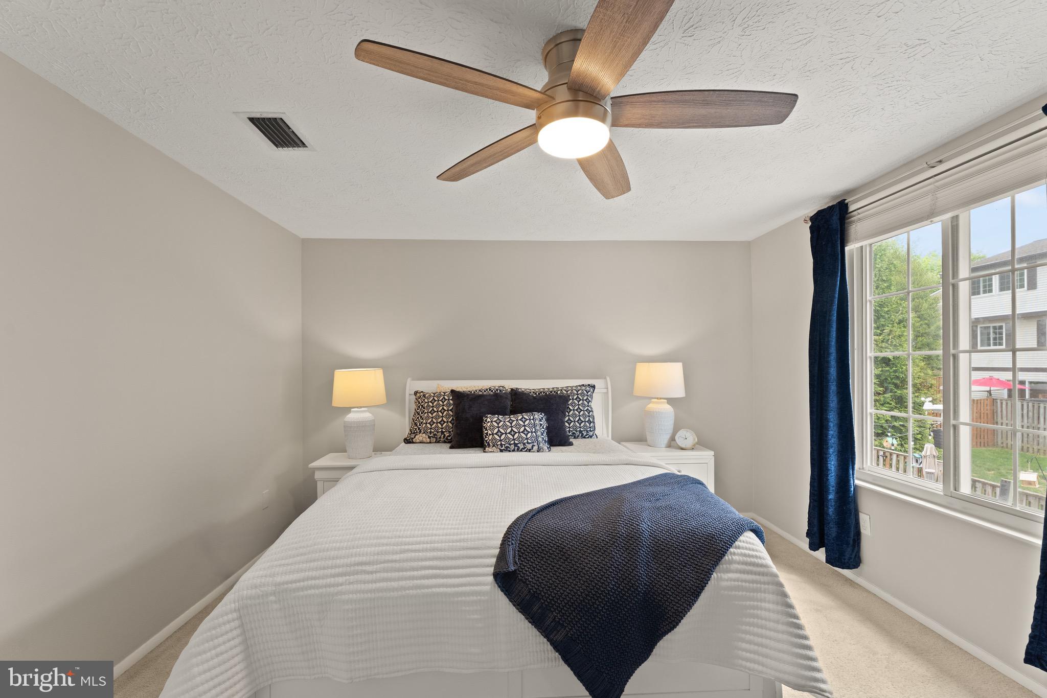 1617 Sierra Woods Drive Reston, VA 20194 - Photo 23 of 39 a bedroom with a bed and a large window
