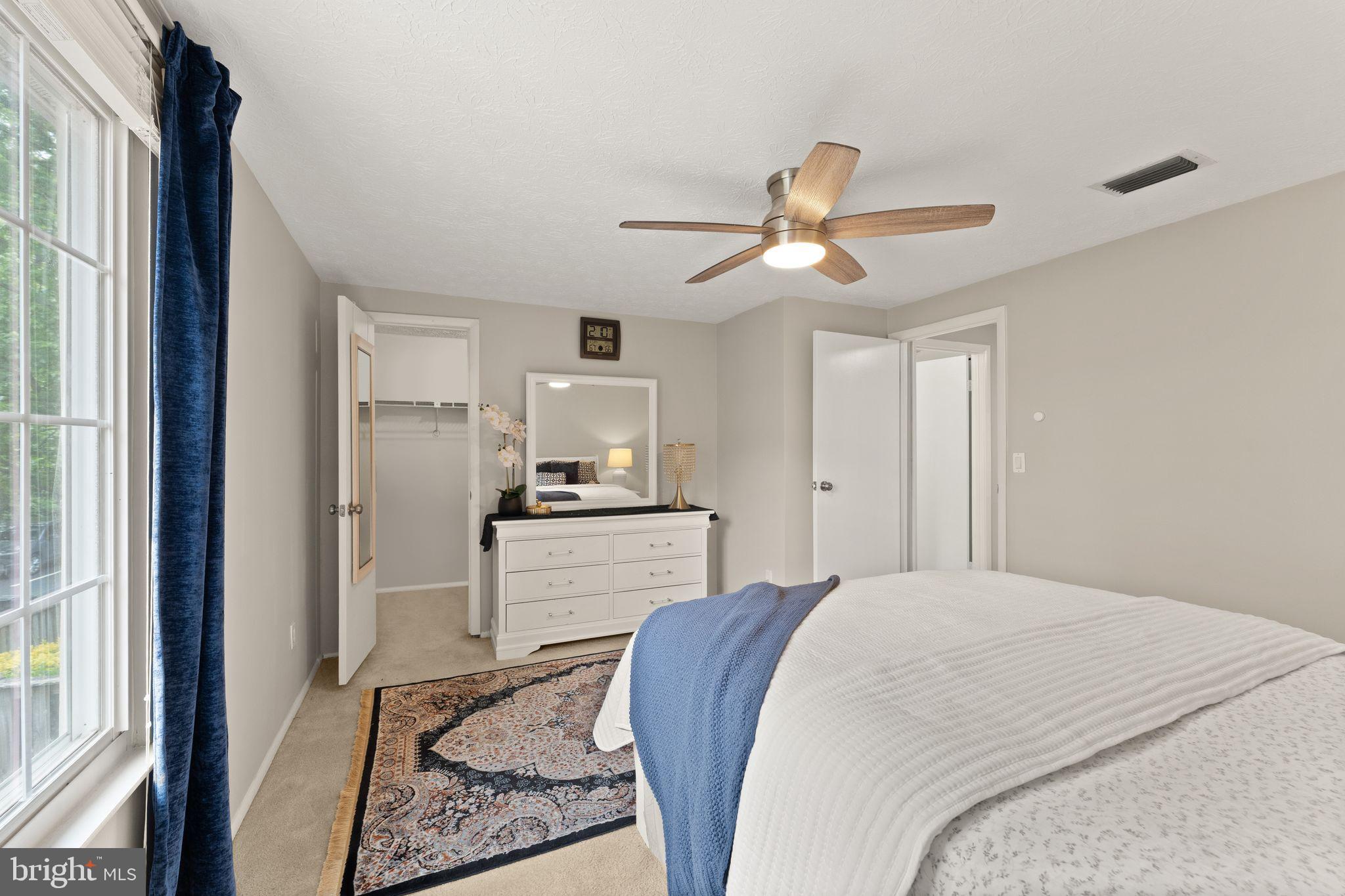 1617 Sierra Woods Drive Reston, VA 20194 - Photo 24 of 39 a bedroom with a bed and a chandelier