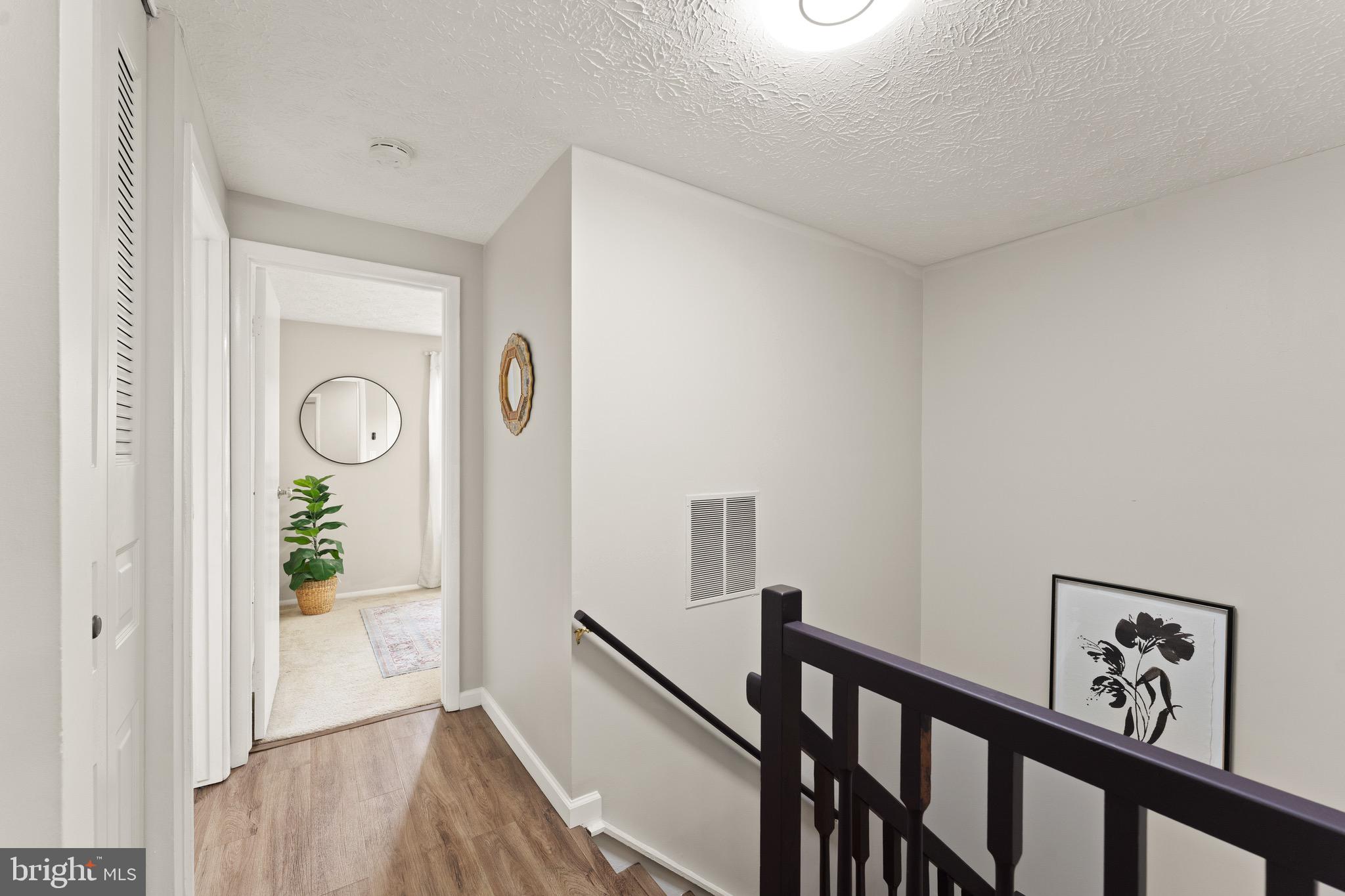 1617 Sierra Woods Drive Reston, VA 20194 - Photo 26 of 39 a view of a hallway with wooden floor and stairs