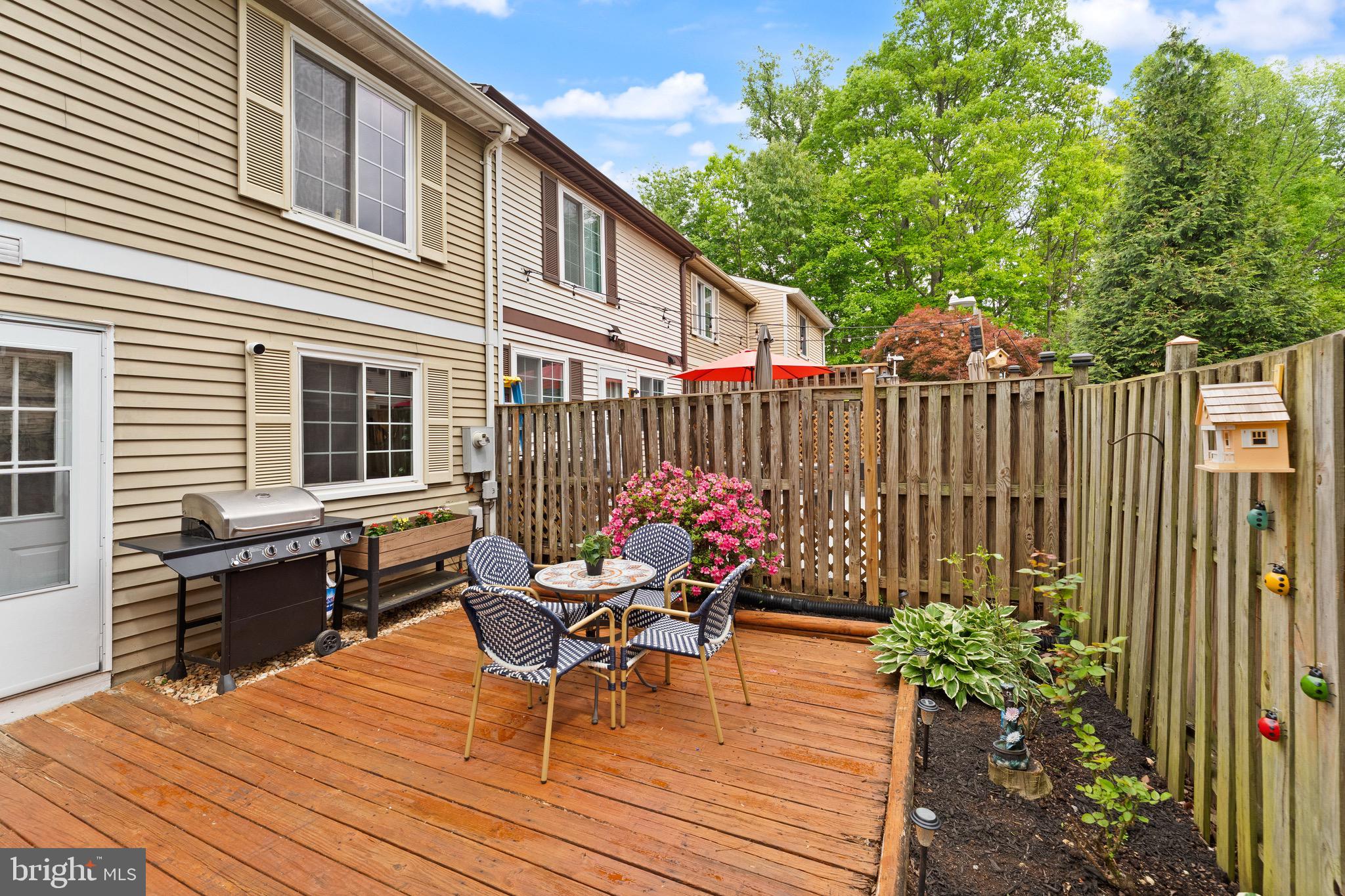 1617 Sierra Woods Drive Reston, VA 20194 - Photo 36 of 39 a roof deck with table and chairs and potted plants with wooden floor and fence